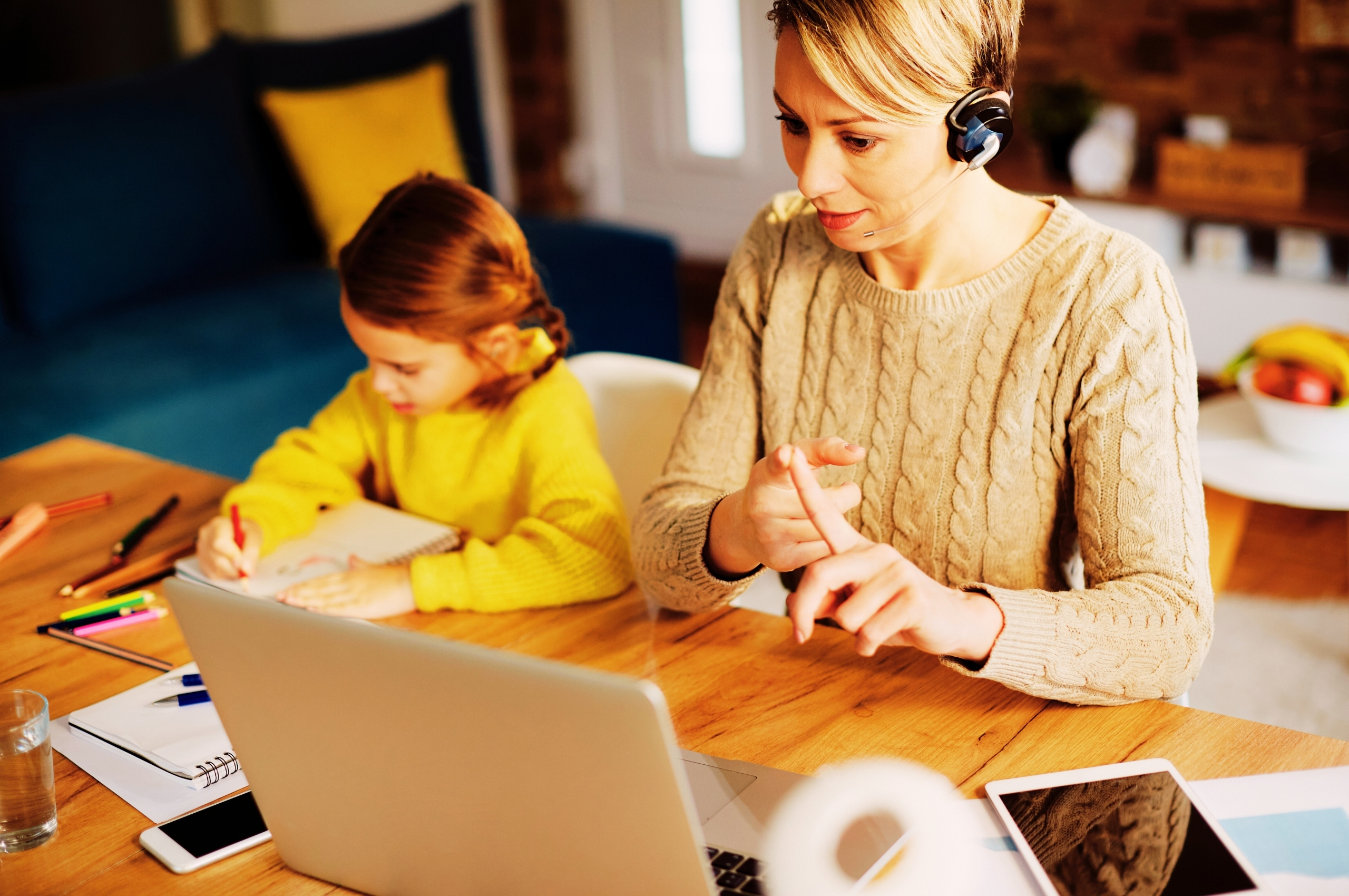 In home tutoring session in the USA with a working mom and child studying at home